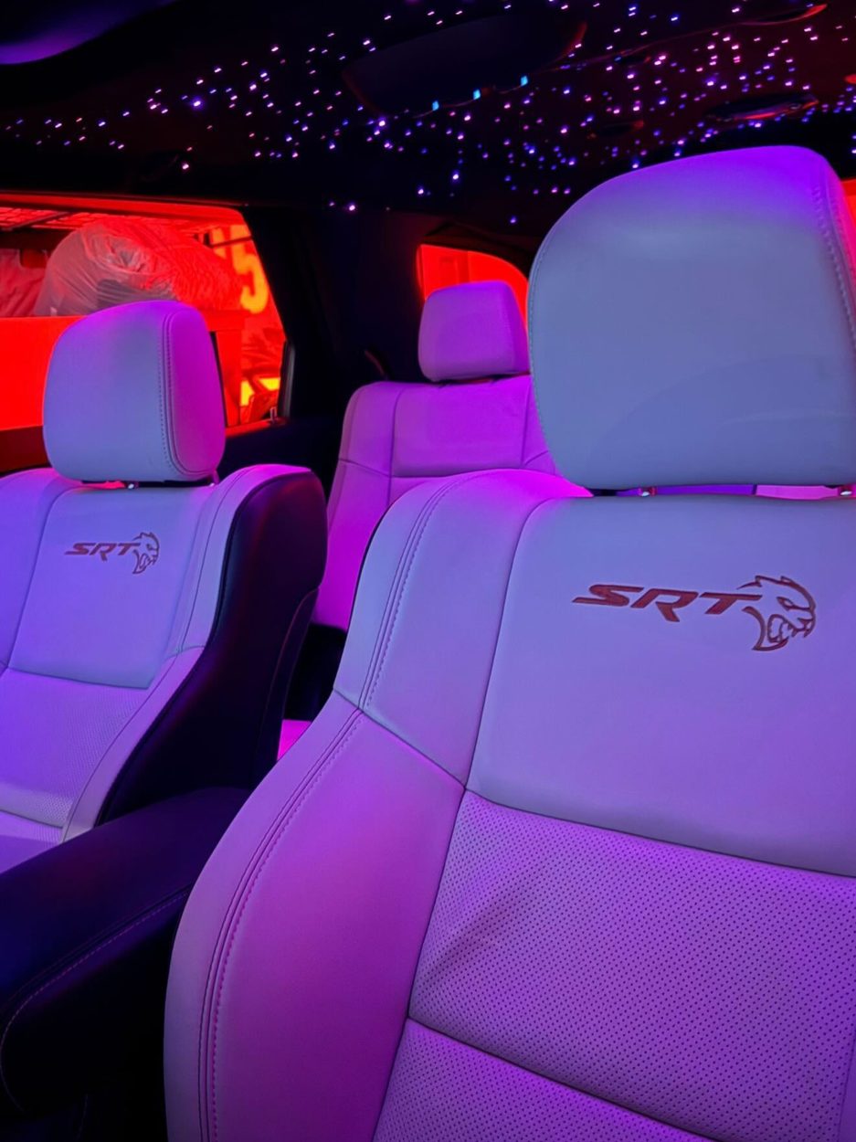 Hellcat Durango SRT seats under a purple and red starlight headliner